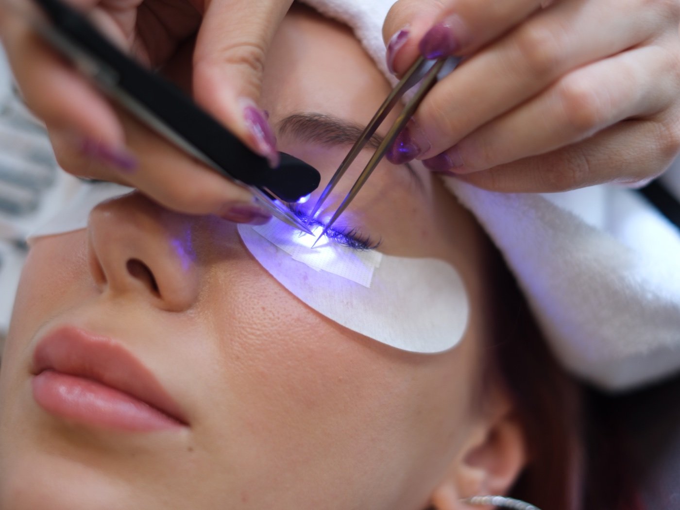 Lash extensions being applied with LED light